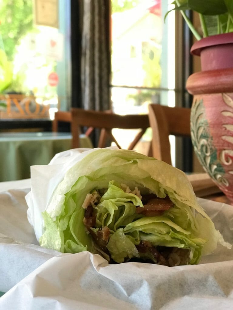 chrysti's choice by chrysti tovani is a keto friendly lettuce wrapped sandwitch served at the fair oaks coffee house and deli that comes with turkey, bacon, cream cheese, jalopena jack, avacado, tomatoe, red onion, with mayonaise and mustard served in a lettuce wrap