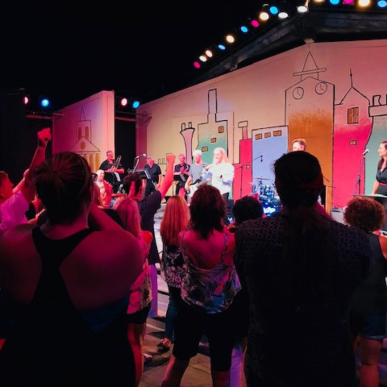 crowd dancing to band on stage