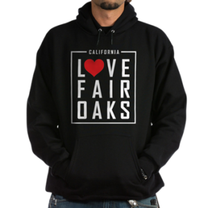 man wearing a hoodie sweatshirt with the love fair oaks logo