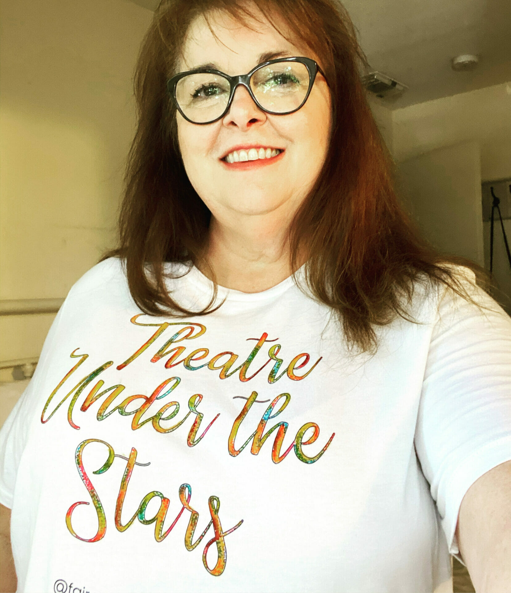 woman wearing theatre under the stars tee shirt