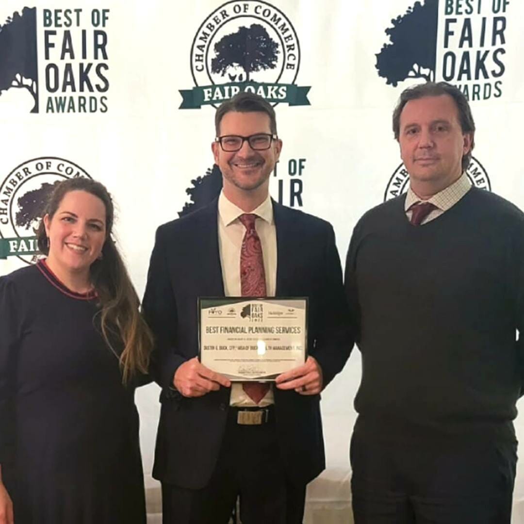 woman and two men holding award