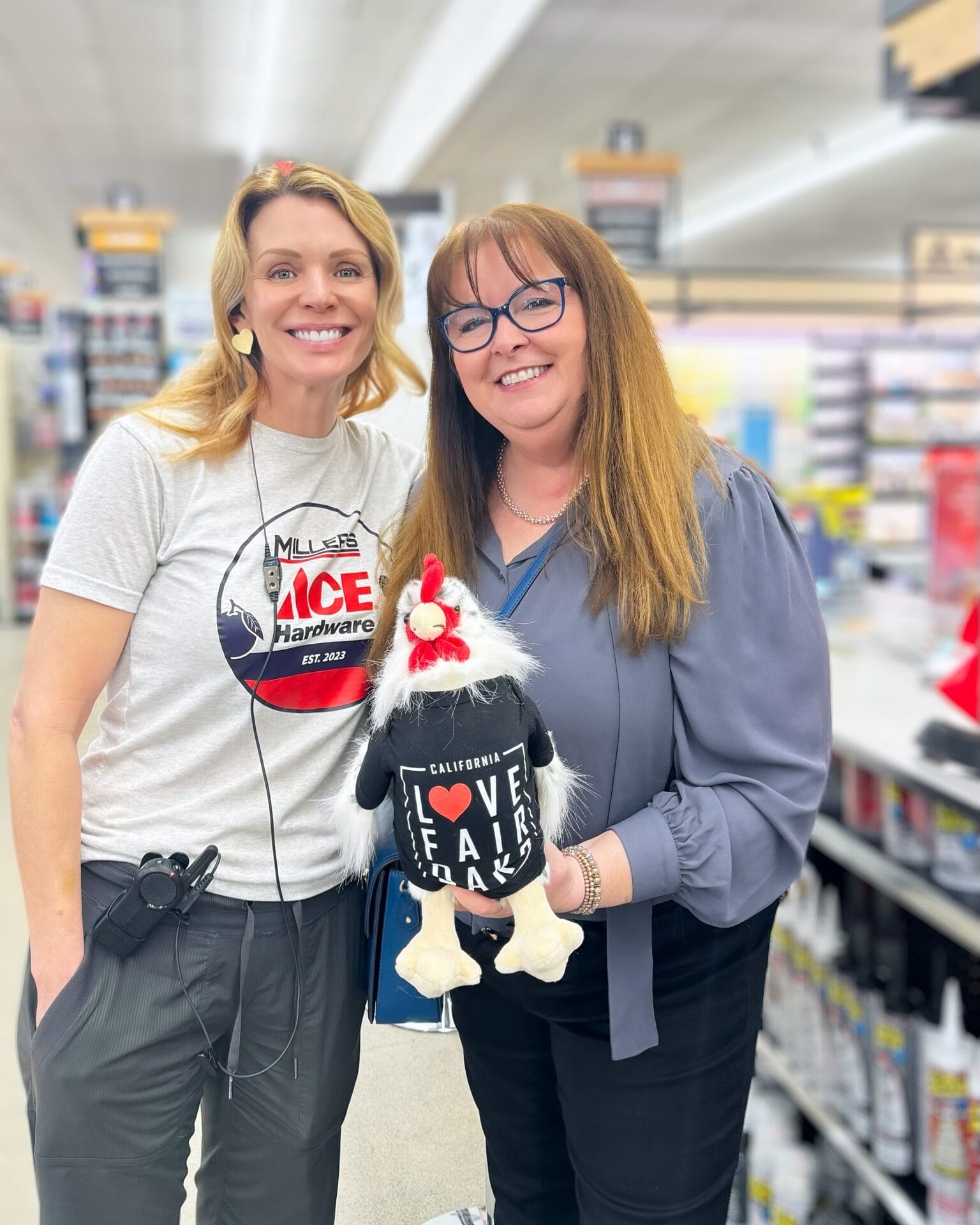 Chrysti Tovani, holding Fair Oaks Finn with Jessica Greenfield, owner of Miller's Ace Hardware