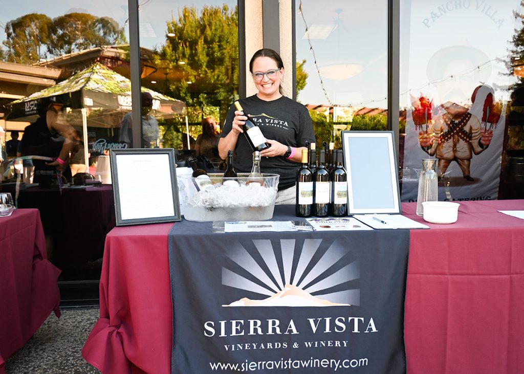 woman serving wine at event