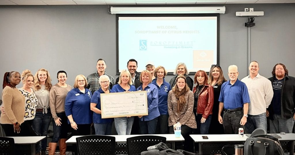 a group of people presenting a big check