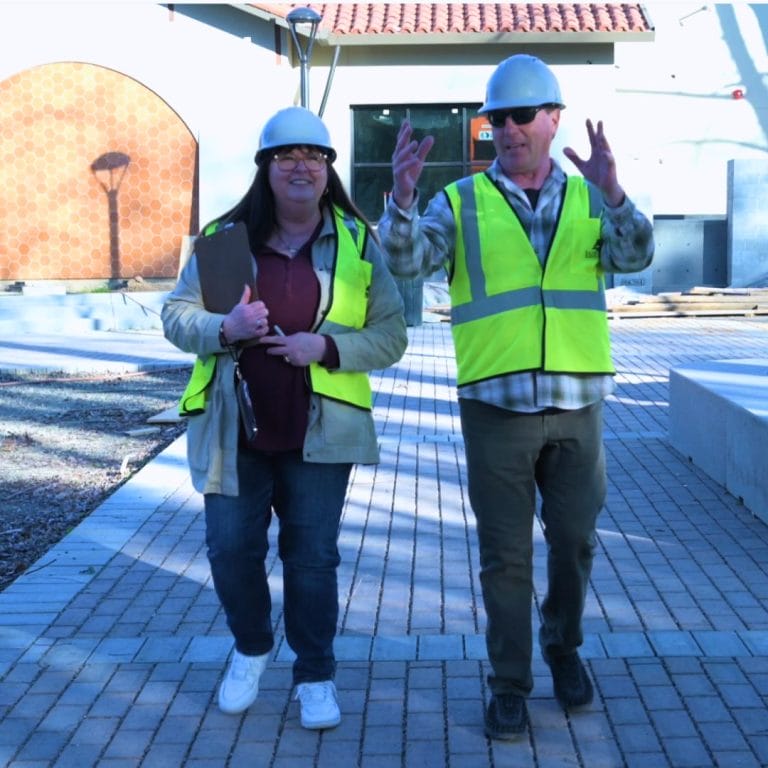 two people wearing yellow vests