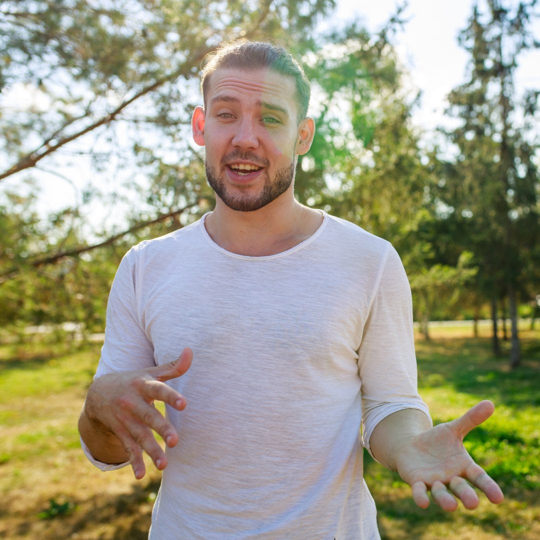man standing outdoors speaking