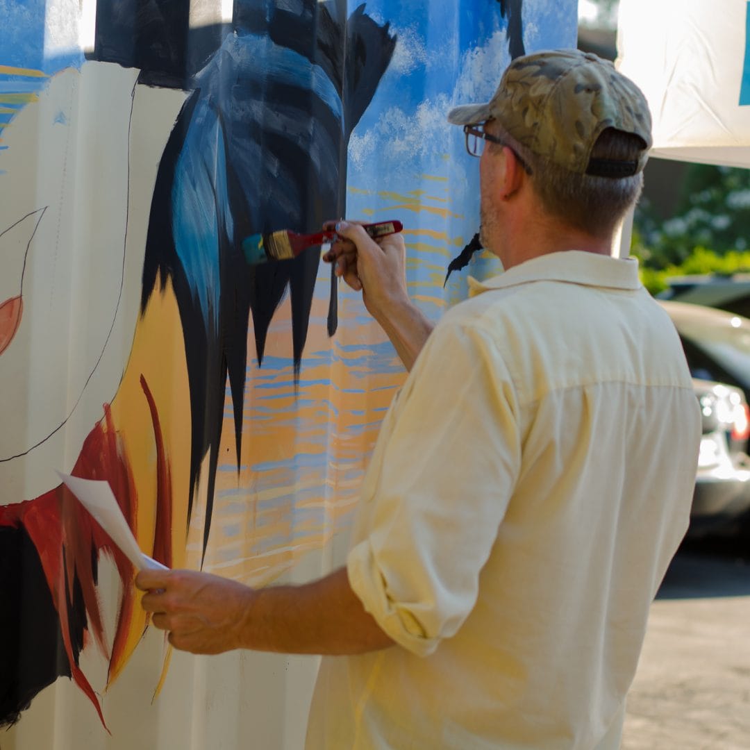 artist painting mural at dads kitchen restaurant in fair oaks