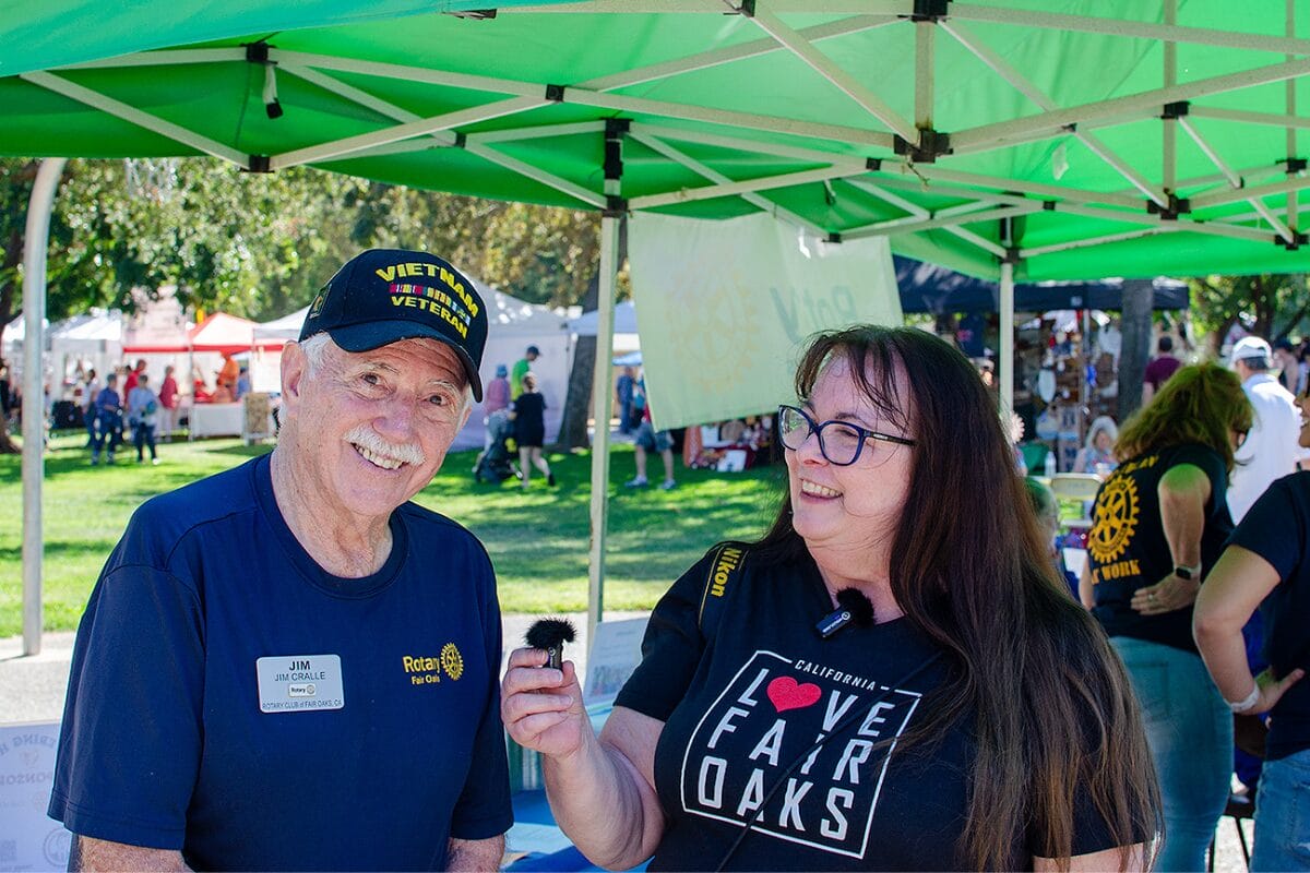 Chrysti Tovani interviewing past president of Fair Oaks Rotary Jim Cralle at the Fair Oaks Chicken Festival
