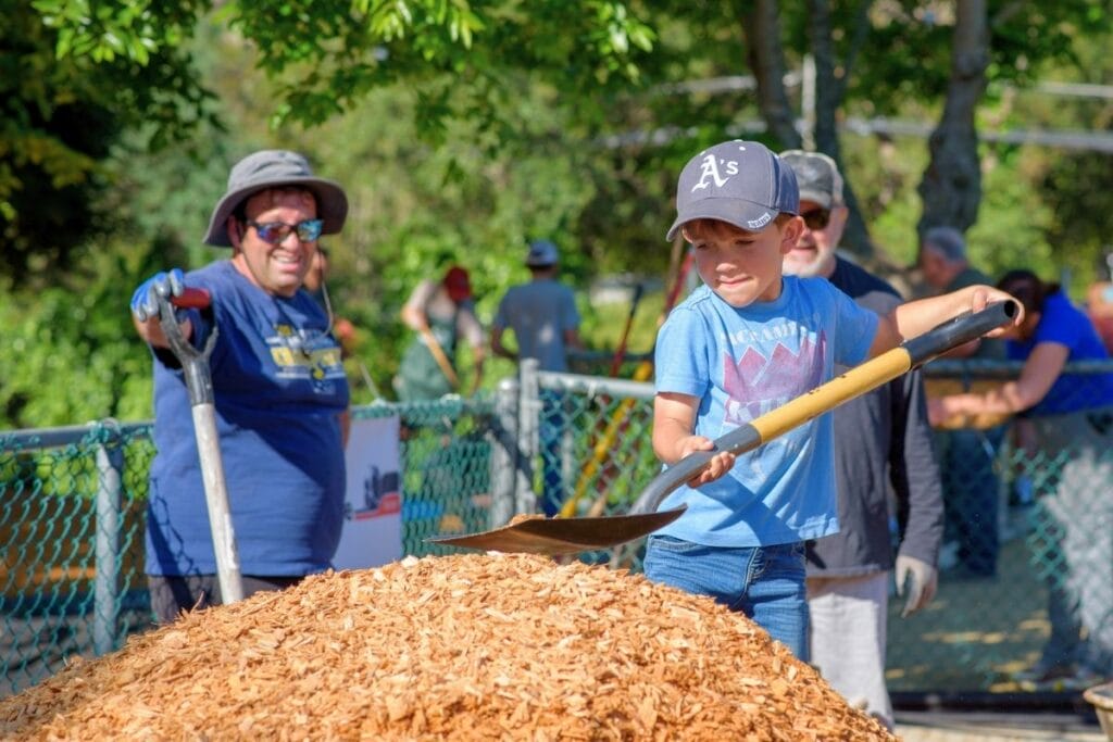 kid shoveling mulch