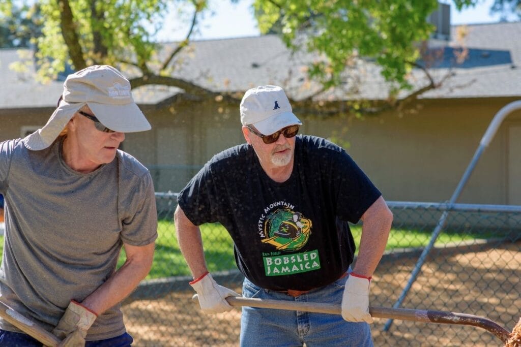 men shoveling mulch fair oaks rotary and infinite friends garden